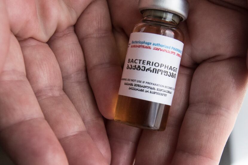 Patti Swearingen holds a vial of bacteriophage that cured her antibiotic-resistant infection...