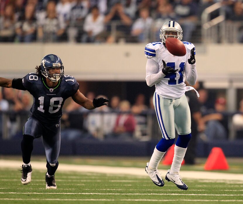 Dallas Cowboys cornerback Terence Newman (41) makes an interception in front of Seattle...