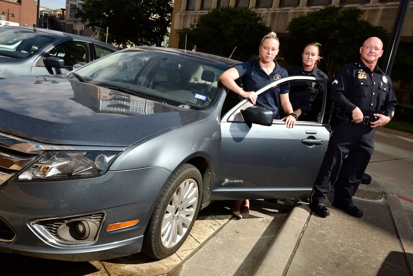 L-R: Dallas Police Officers with the Mobile Surveillance Unit, Manager Emily Davis, left,...