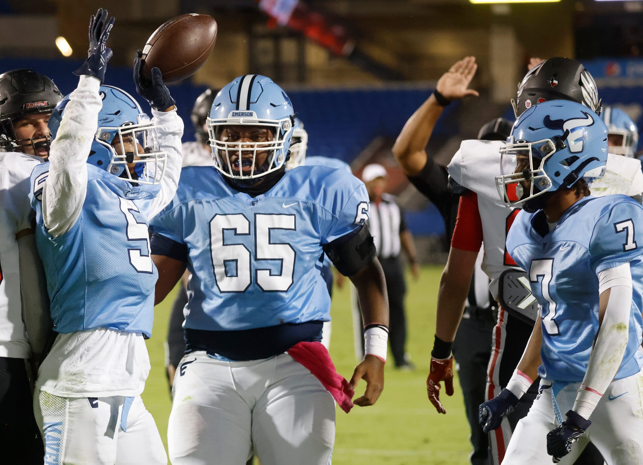 Emerson’s Bills Ishaqq (5), left, celebrates after a touchdown against Argyle high school...