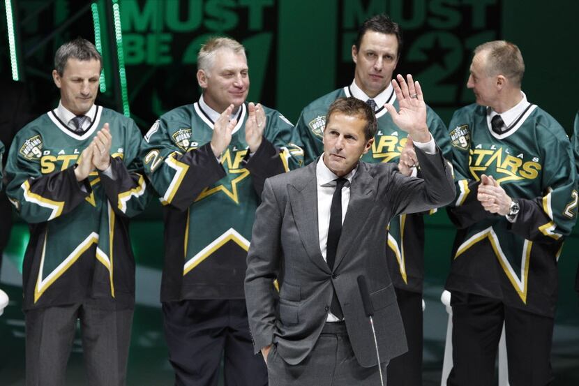 Surrounded by his teammates from the 1999 Dallas Stars, Mike Modano makes remarks during a...