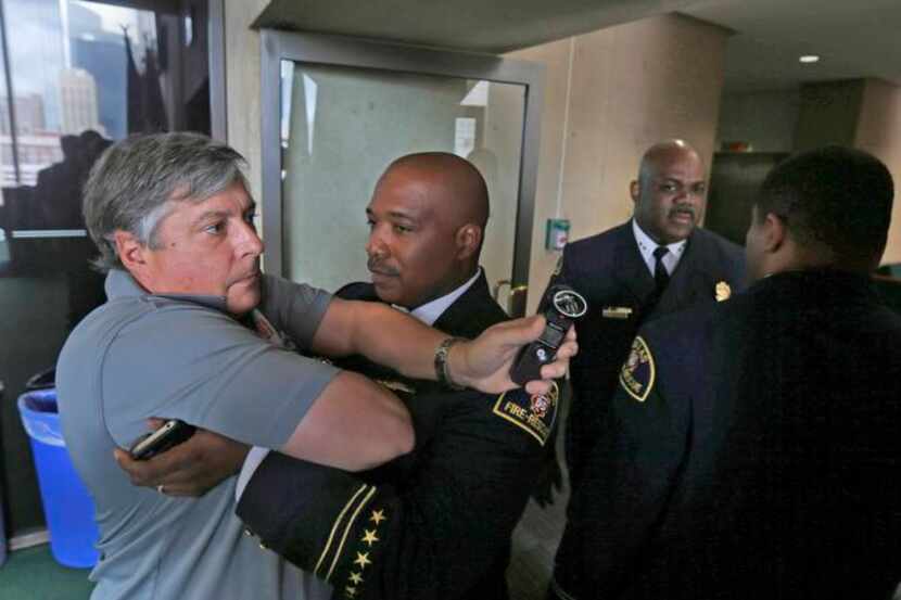 
L.P. Phillips, a reporter for KRLD-AM (1080), was restrained from following Fire Chief...