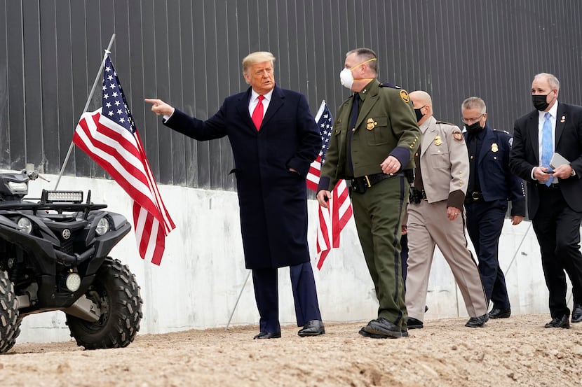 President Donald Trump tours a section of the U.S.-Mexico border wall under construction...