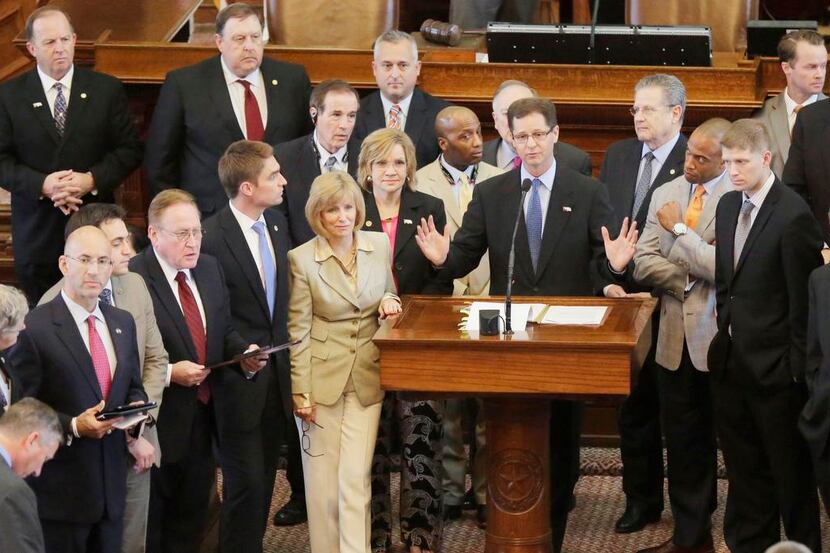 
Rep. Scott Sanford (center), R-McKinney, a Baptist minister, was joined Thursday by other...