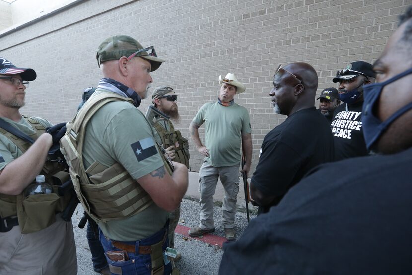 Protesters discussed their views after Tuesday's City Council meeting.