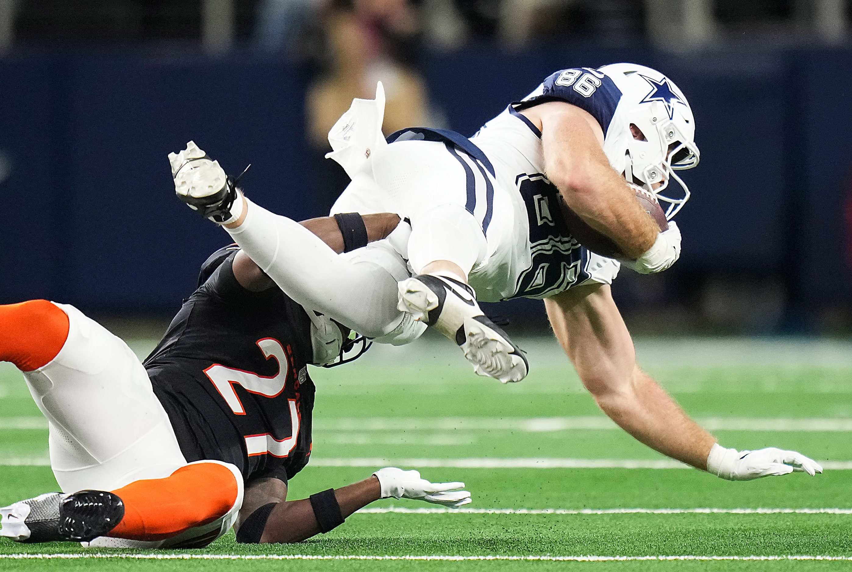 Dallas Cowboys tight end Luke Schoonmaker (86) is knocked off his feet by Cincinnati Bengals...