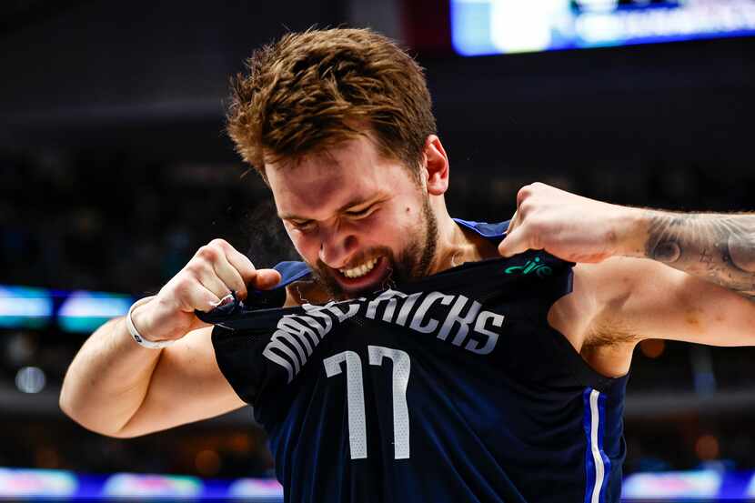 Dallas Mavericks guard Luka Doncic (77) rips his jersey in frustration after missing the...