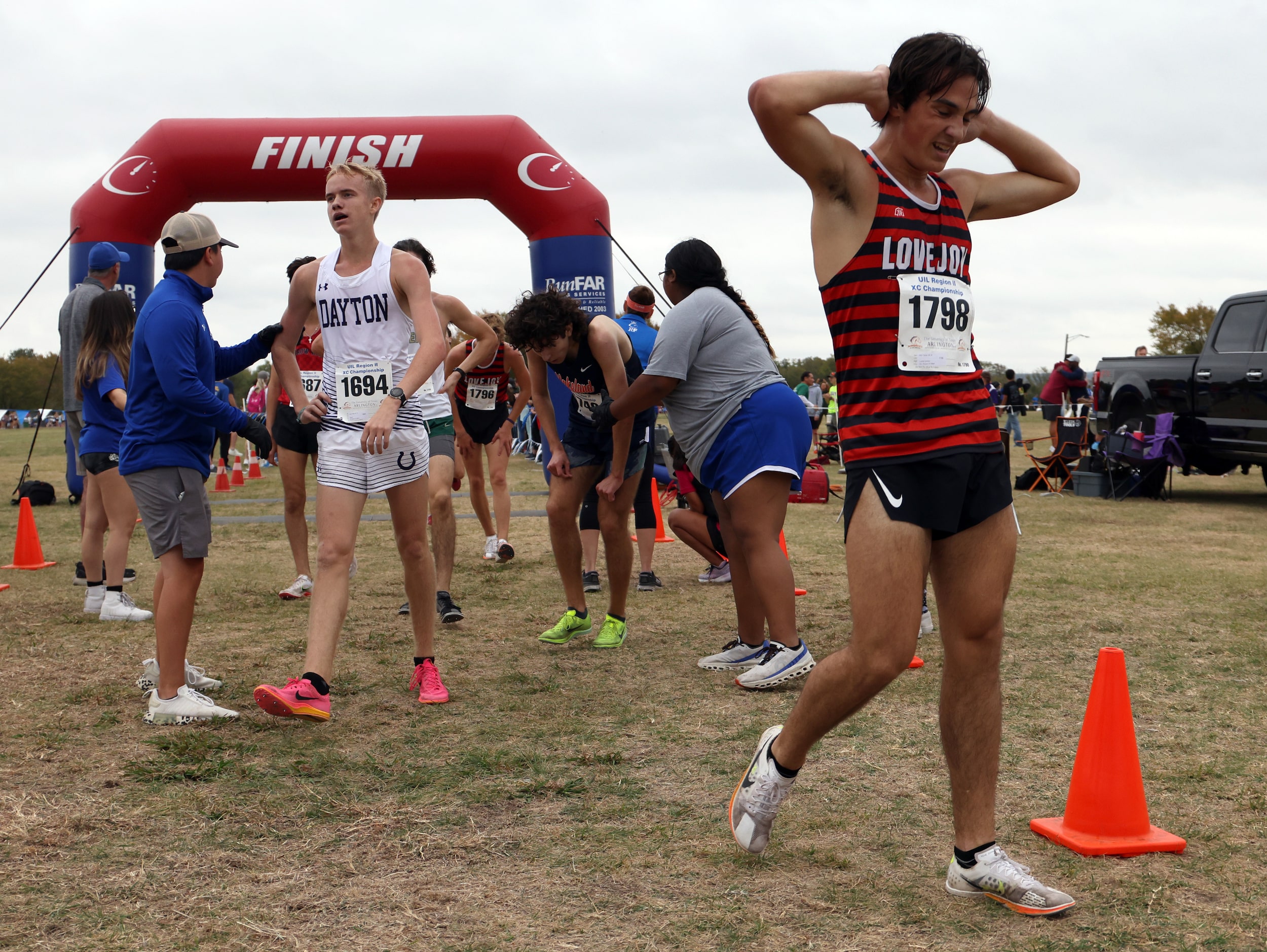 Lucas Lovejoy senior Nick Yarad (1798), right, catches his breath after crossing the finish...