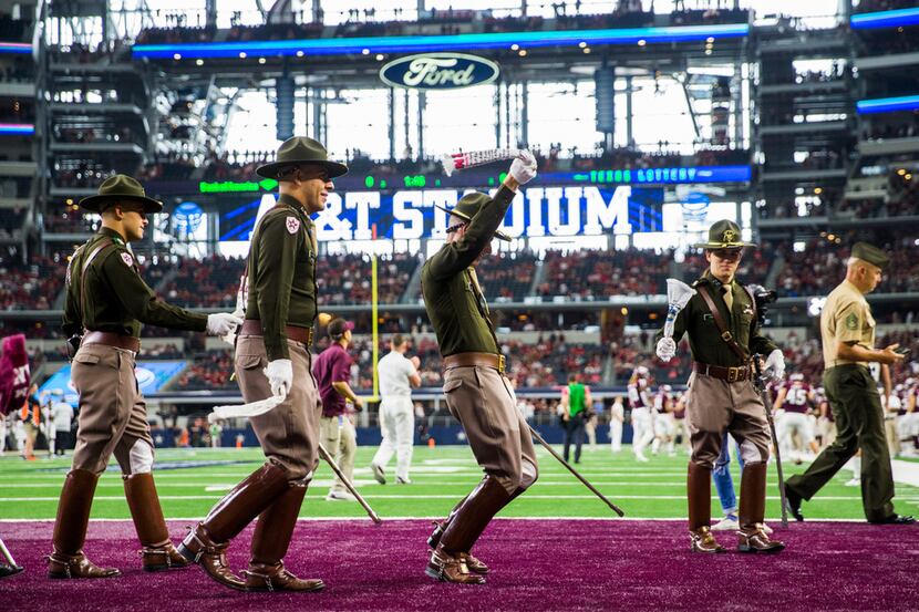 Members of the Texas A&M Aggies Corps of Cadets yell on the sidelines before an NCAA...