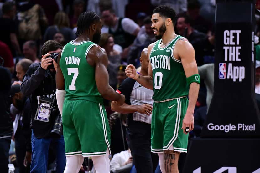 Boston Celtics forward Jayson Tatum (0) congratulates guard Jaylen Brown (7) after they...