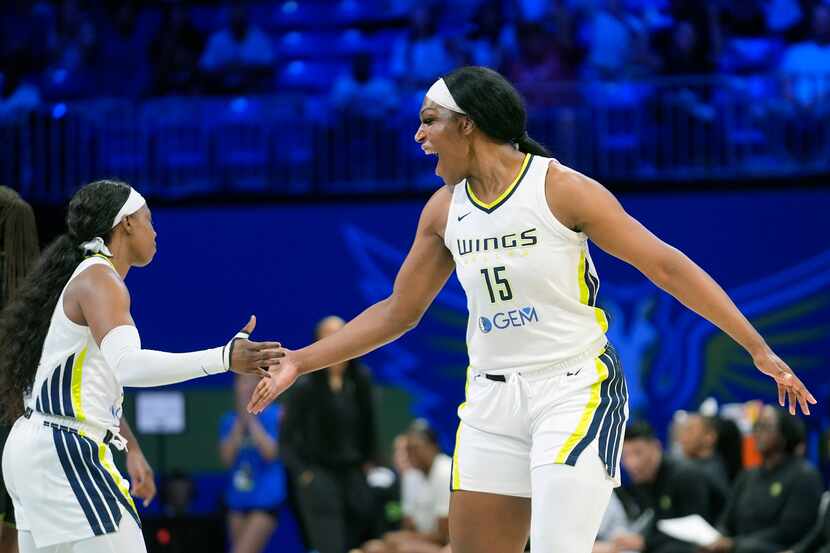 Dallas Wings center Teaira McCowan (15) celebrates a play against the Seattle Storm with...