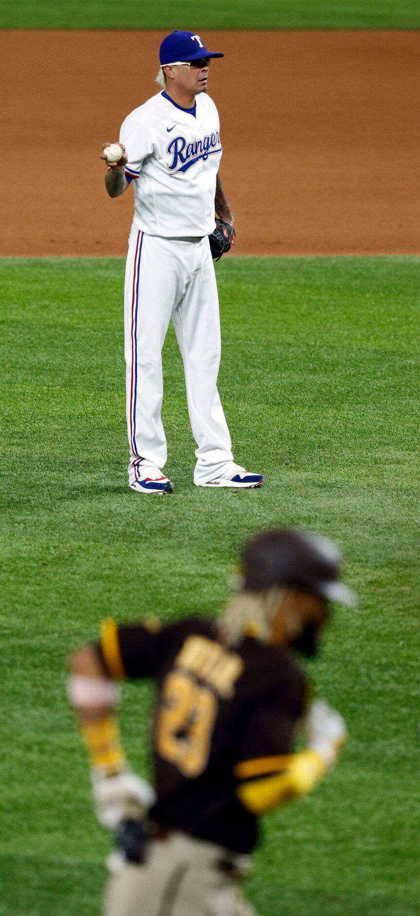 Texas Rangers relief pitcher Jesse Chavez (30) waits as San Diego Padres Fernando Tatis Jr....