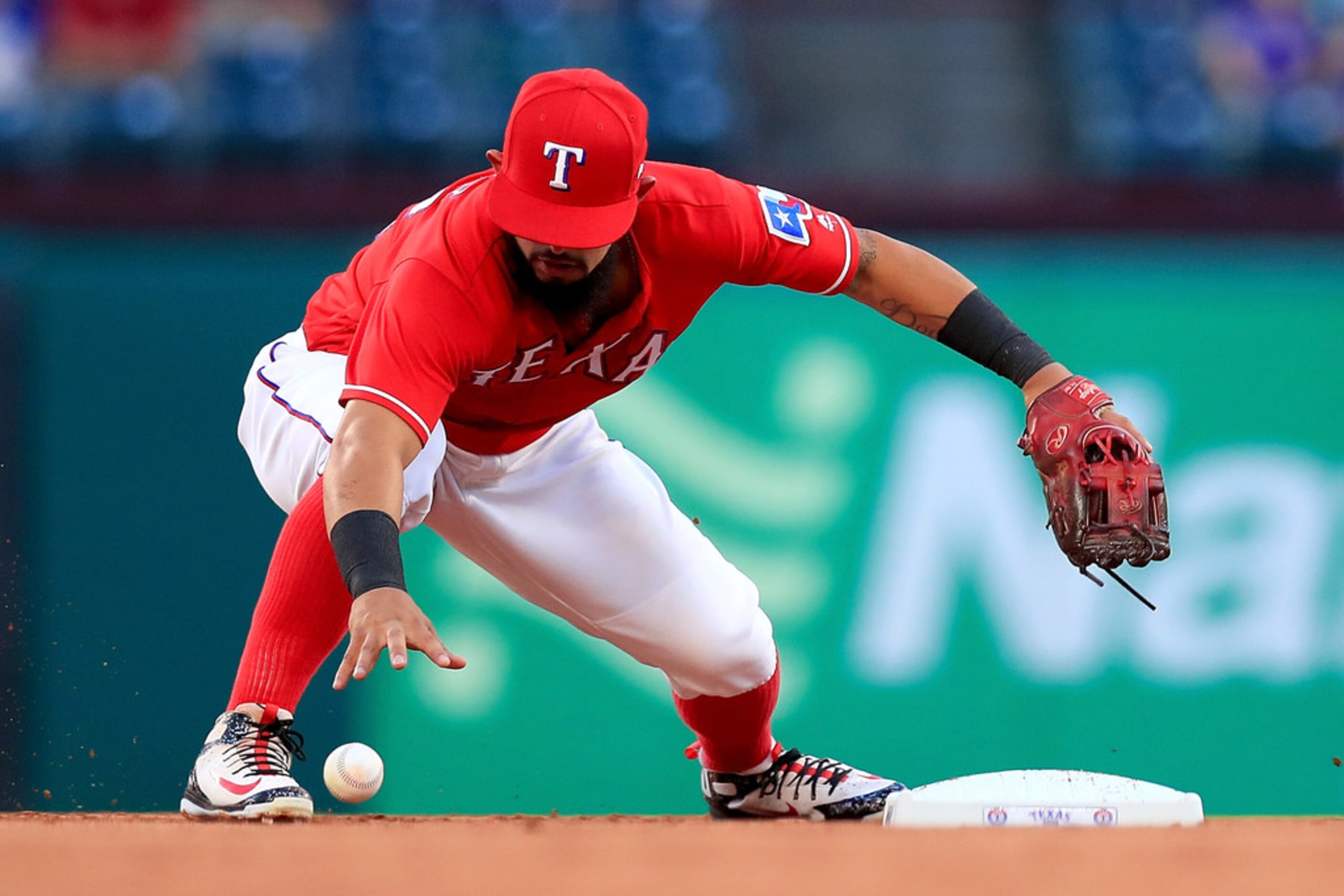 ARLINGTON, TX - AUGUST 28:  Rougned Odor #12 of the Texas Rangers commits an error fielding...