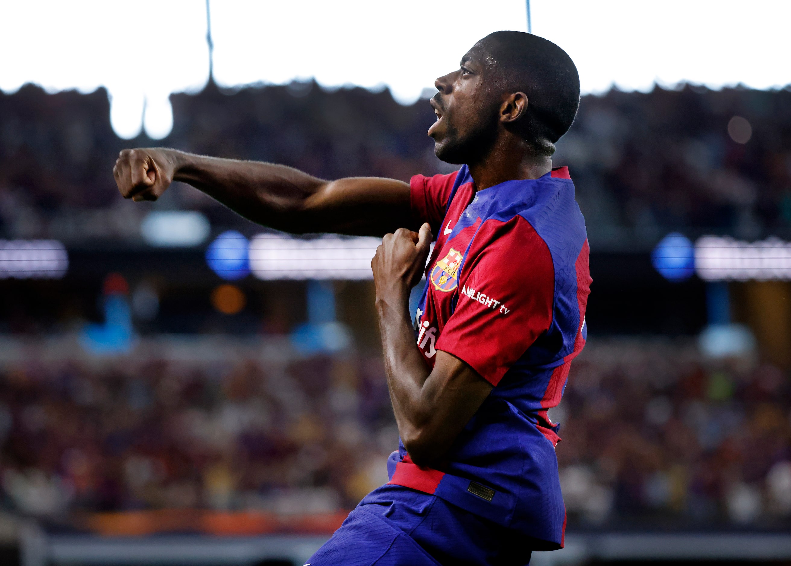 Barcelona forward Ousmane Dembélé (7) celebrates his first half score on Real Madrid...