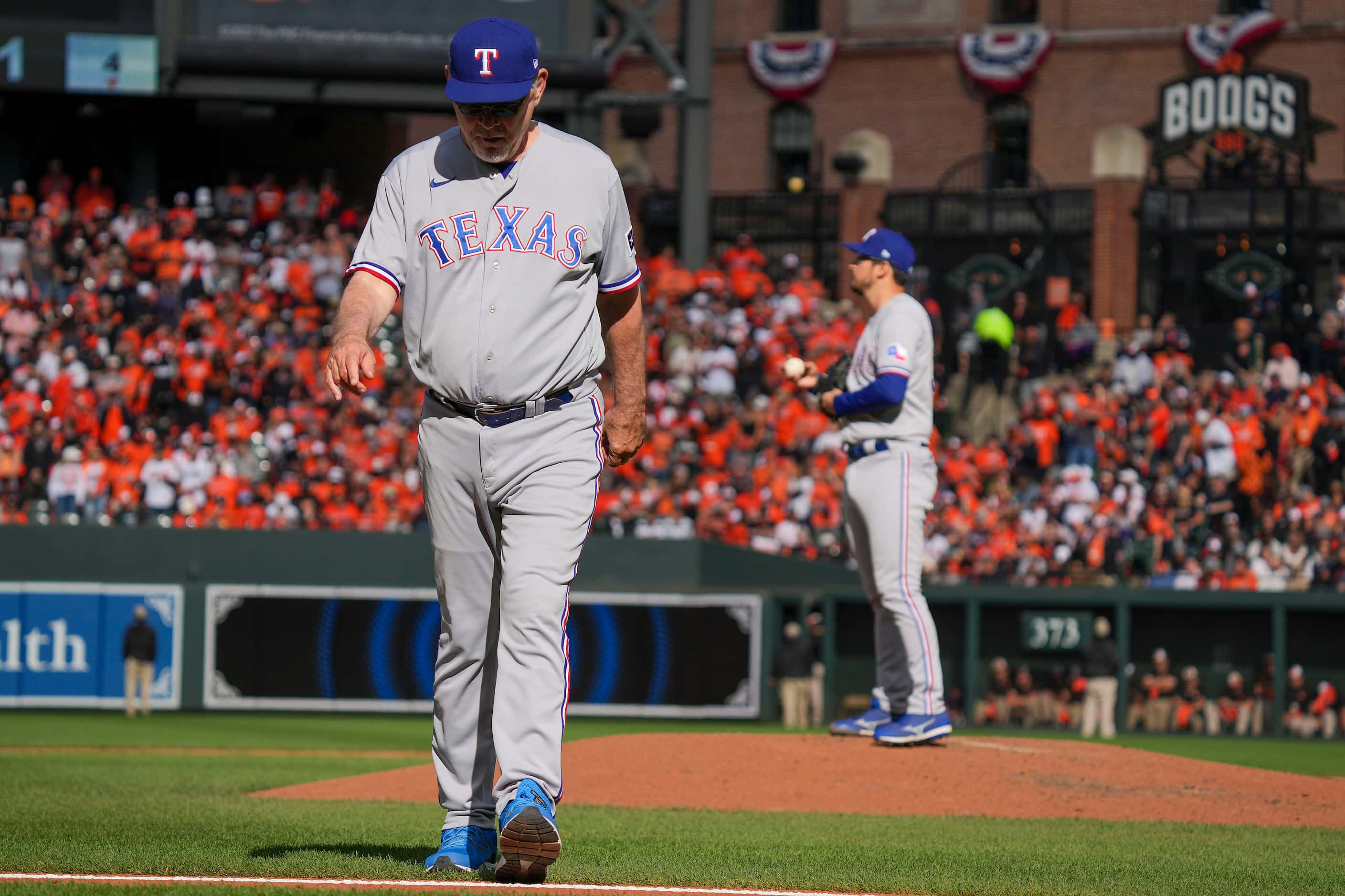 Texas Rangers manager Bruce Bochy heads back to the dugout after bringing in pitcher Dane...