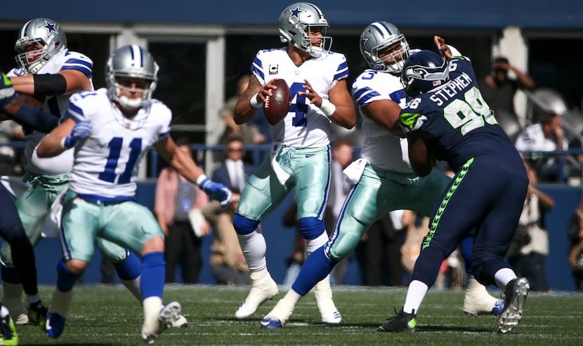 Dallas Cowboys quarterback Dak Prescott (4) looks to make a pass during the first quarter of...