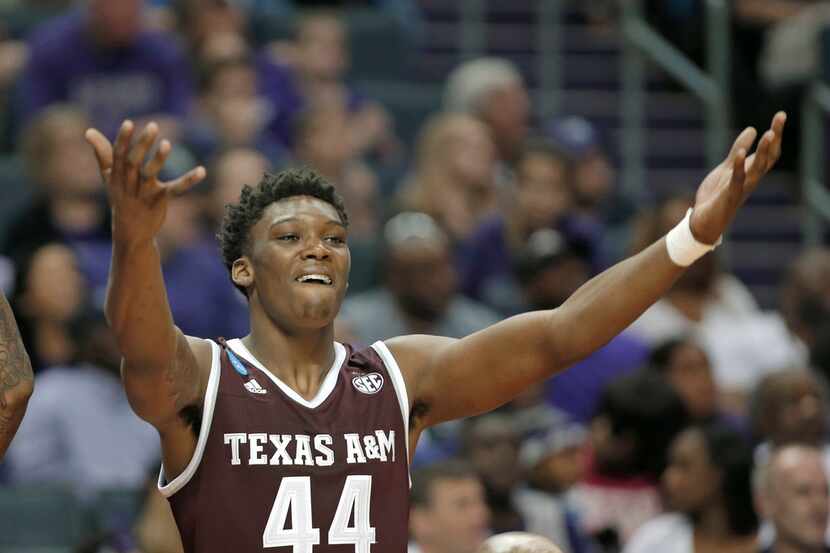 Texas A&M's Robert Williams (44) celebrates on the bench during the second half of a...