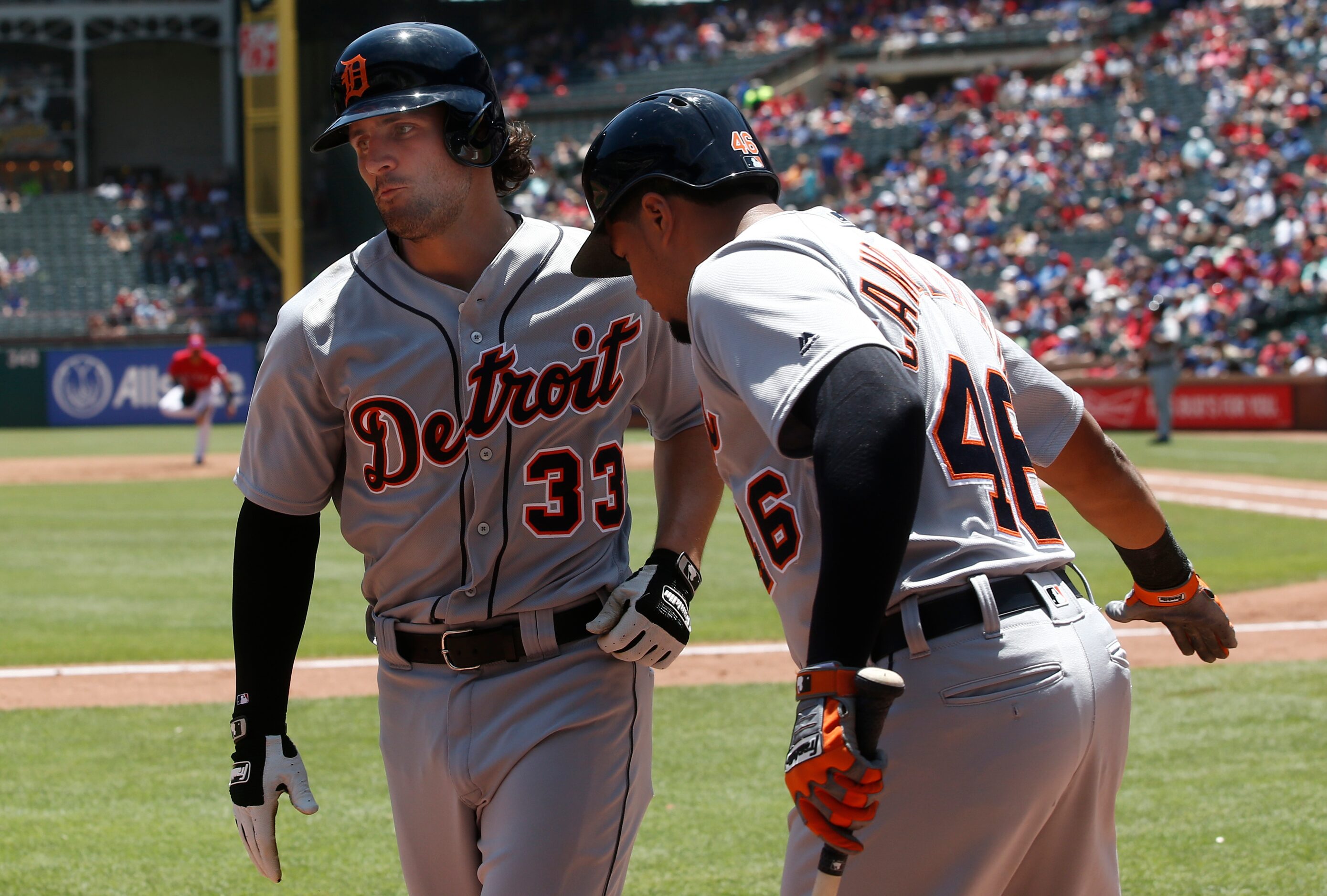 Detroit Tigers' Pete Kozma (33) is congratulated by Jeimer Candelario (46) after hitting a...