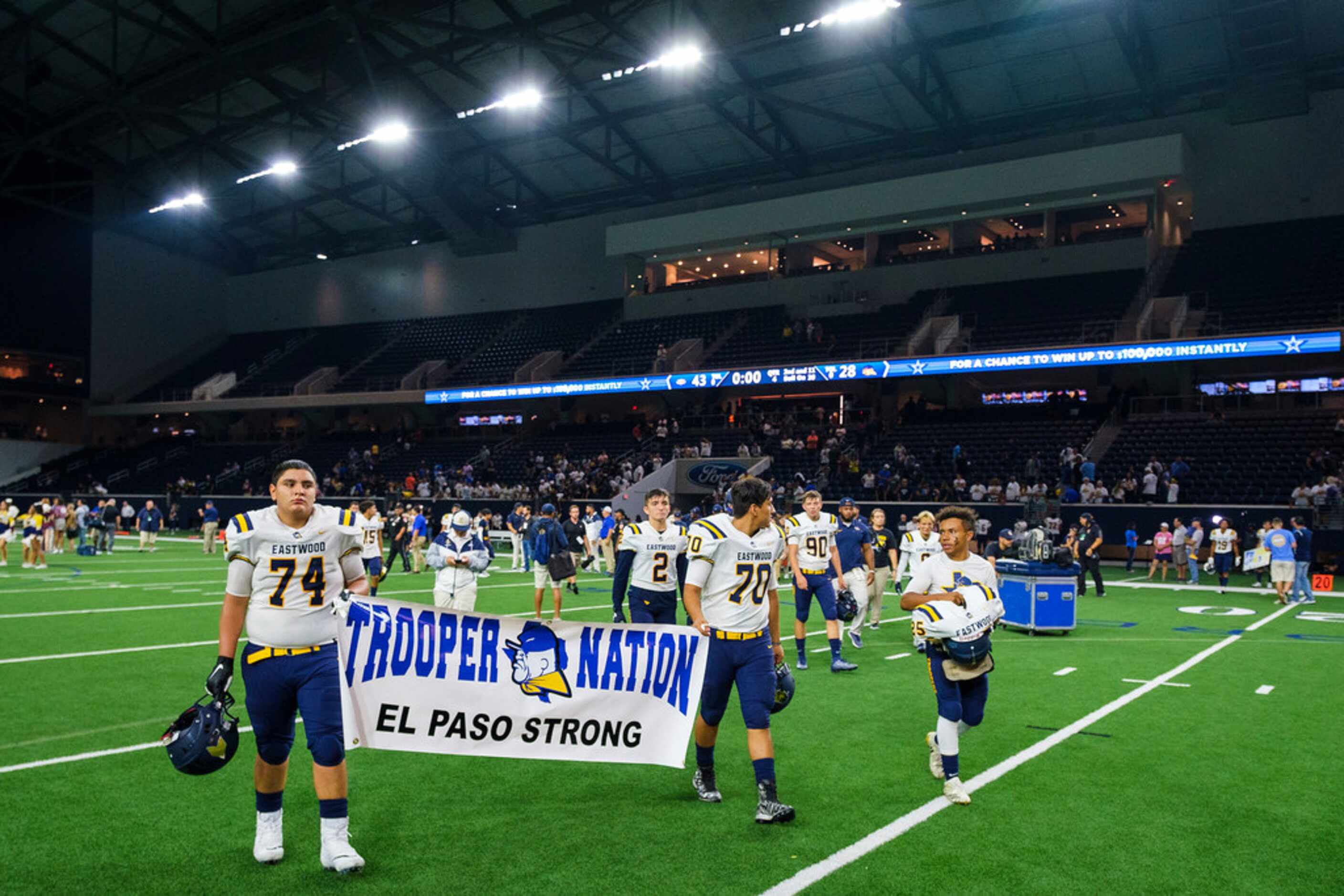 El Paso Eastwood linemen Jonathan Grajeda (74) and Victor Soto (70) carry a banner off the...