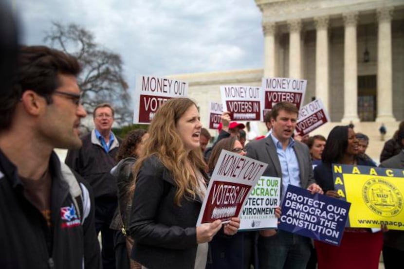 Protesters rally Wednesday outside the Supreme Court, before a decision in a case involving...