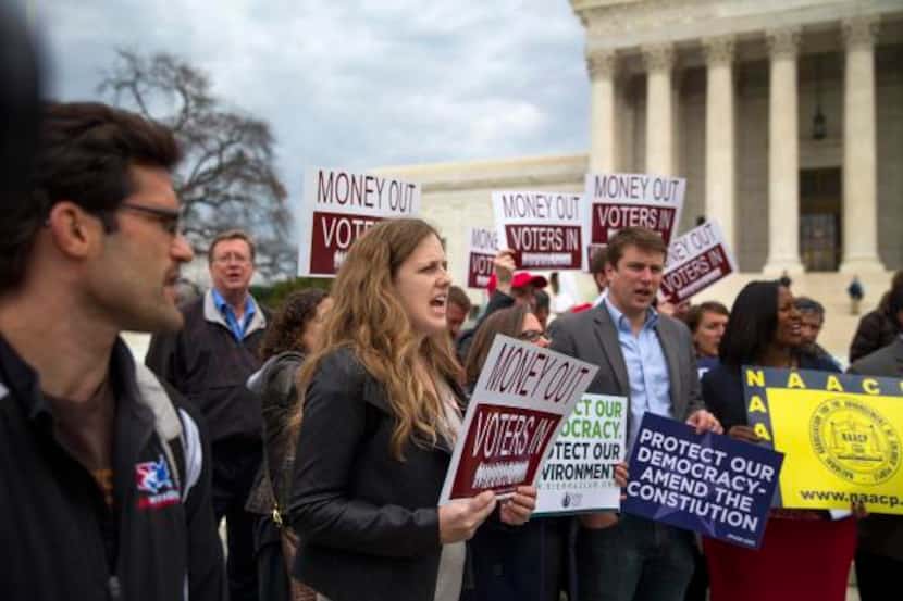 
Protesters rally Wednesday outside the Supreme Court, which issued a major campaign finance...