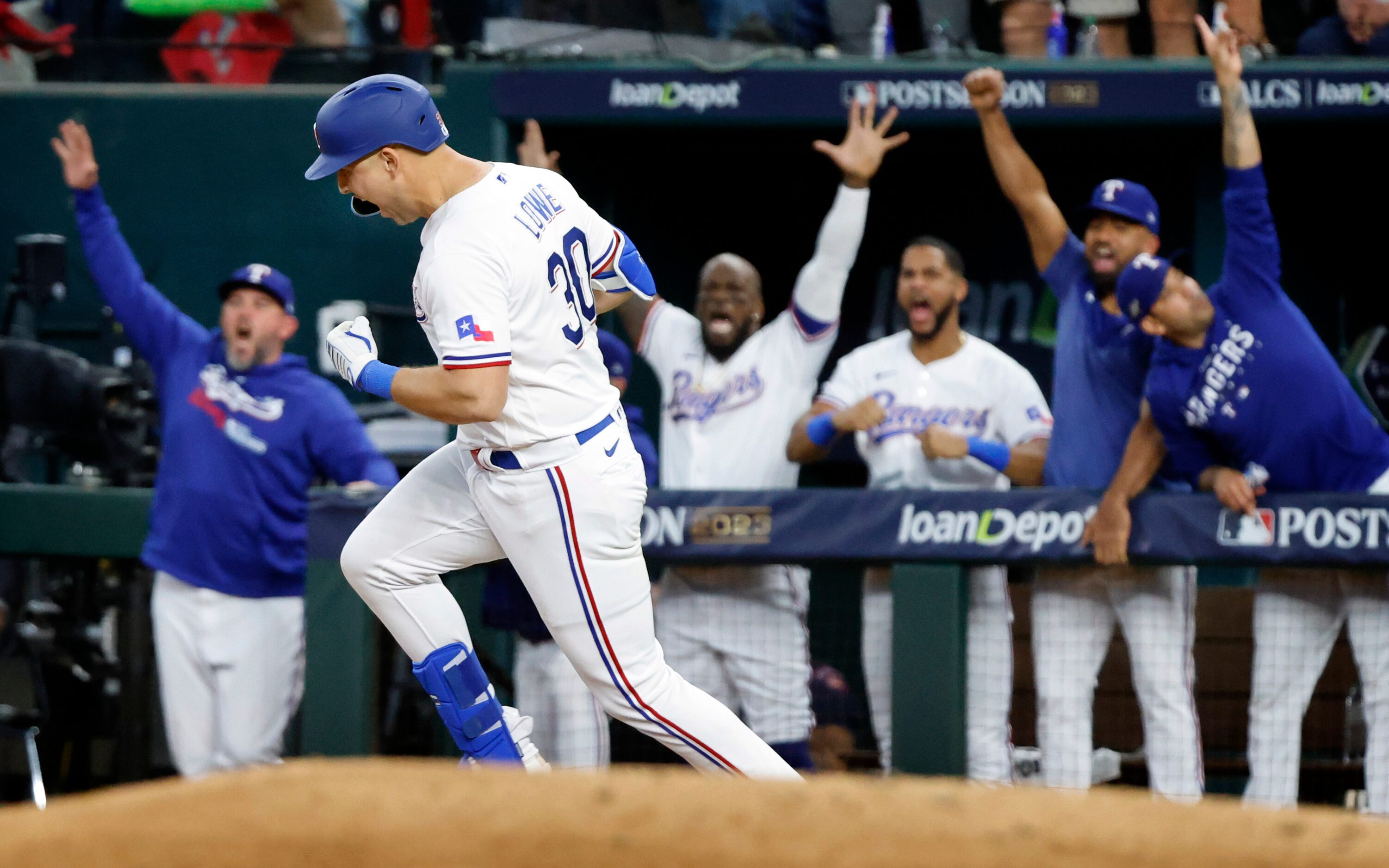 Texas Rangers batter Nathaniel Lowe (30) rounds first on his fifth inning solo home run in...