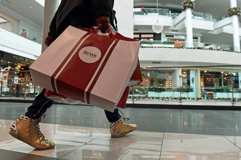 FILE- In this Dec. 22, 2017, file photo, people shop at the Pentagon City Mall in Arlington,...
