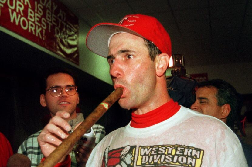 9/28/96---Rangers first baseman Will Clark  takes a hit the victory cigar in the champagne...