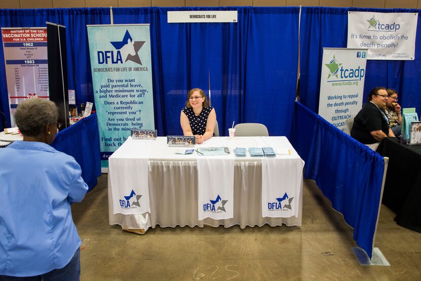 Volunteer Elizabeth Anderson mans a Democrats for Life of America booth during the Texas...