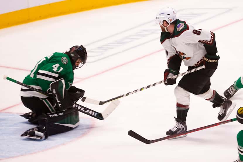 Dallas Stars goaltender Scott Wedgewood (41) stops a goal by Arizona Coyotes right wing Phil...