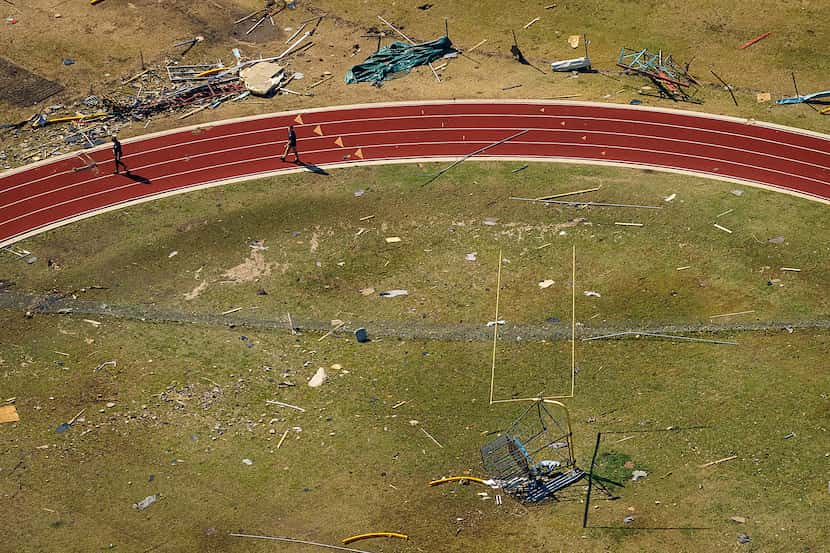 Storm debris lies scattered on an athletic field at Thomas Jefferson High School. 