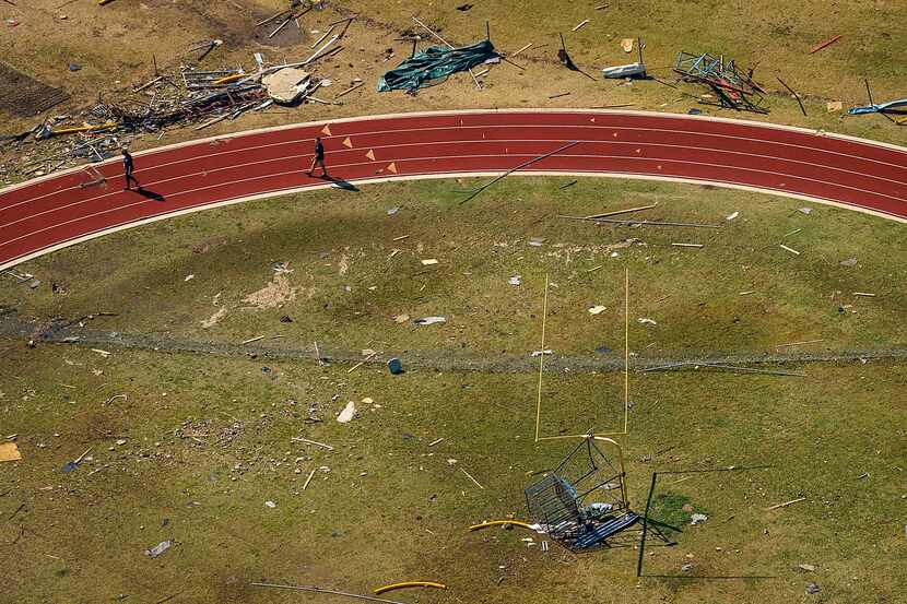 Storm debris lies scattered on an athletic field at Thomas Jefferson High School. 