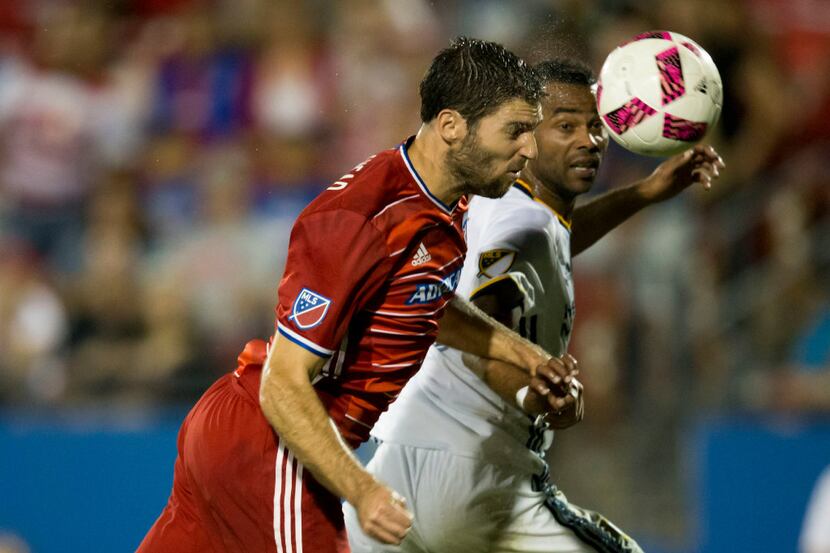 FC Dallas midfielder Ryan Hollingshead (12) heads the ball for a shot on goal during a MLS...
