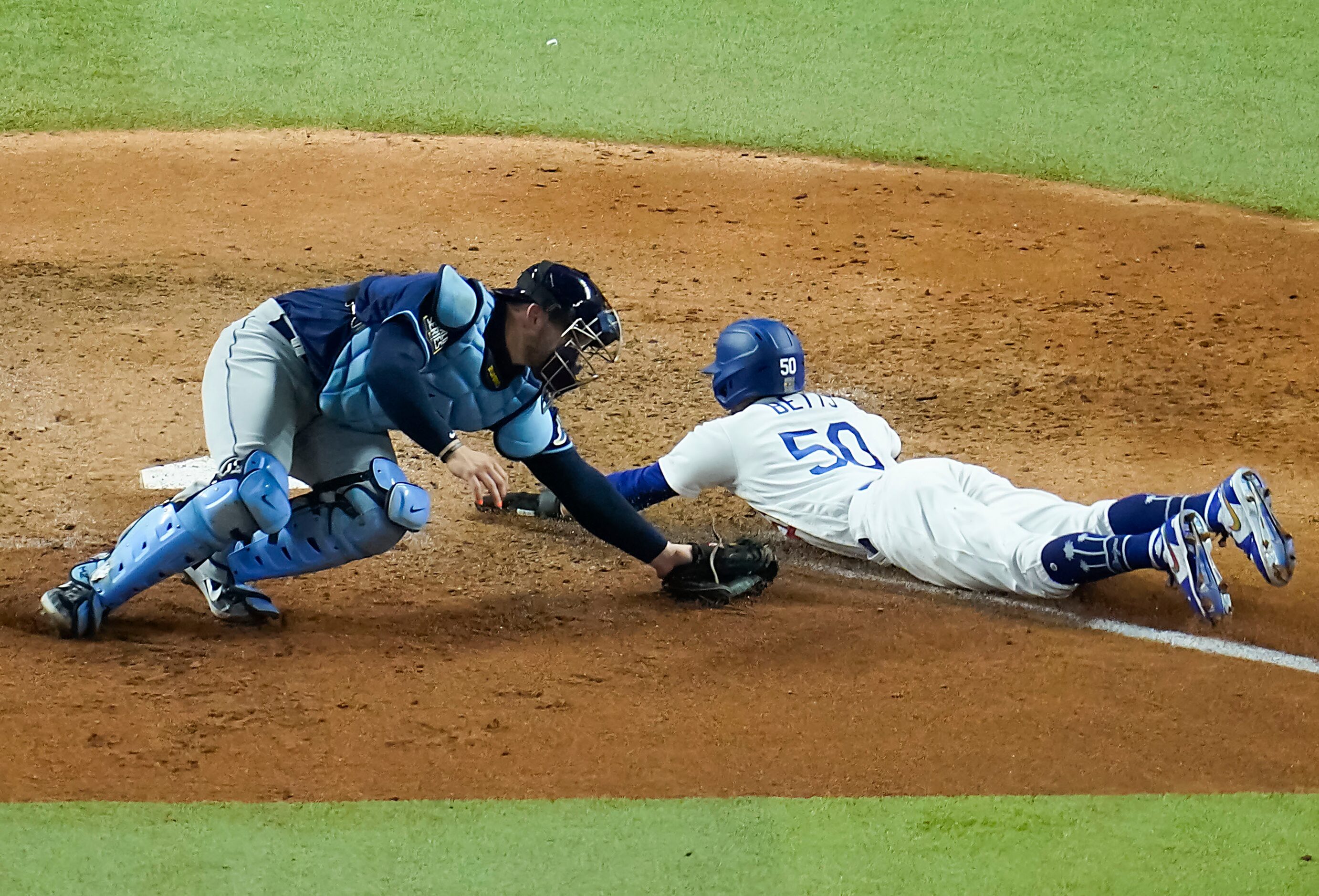 Los Angeles Dodgers right fielder Mookie Betts scores on a fielders choice grounder by first...