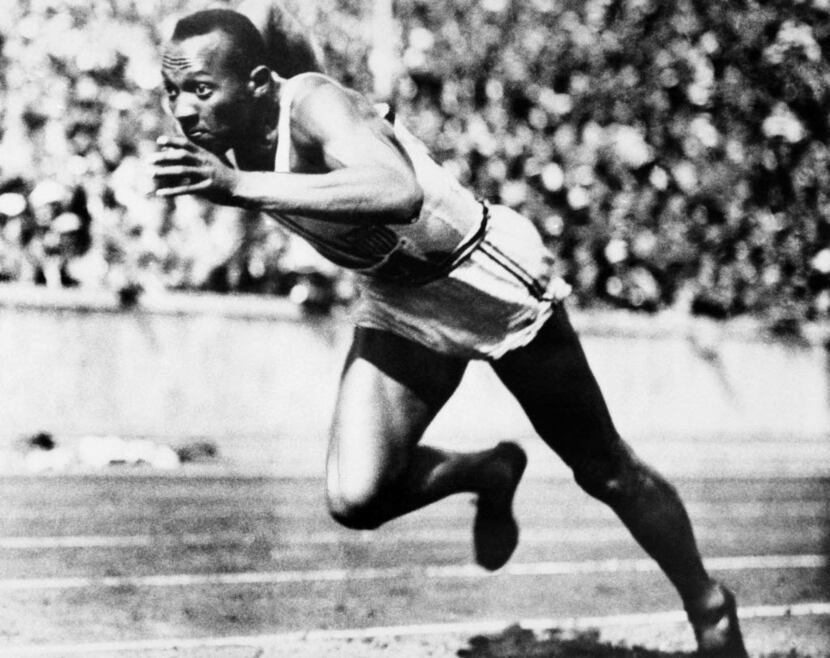 Jesse Owens competed in one of the heats of the 200-meter run at the 1936 Olympic Games in...