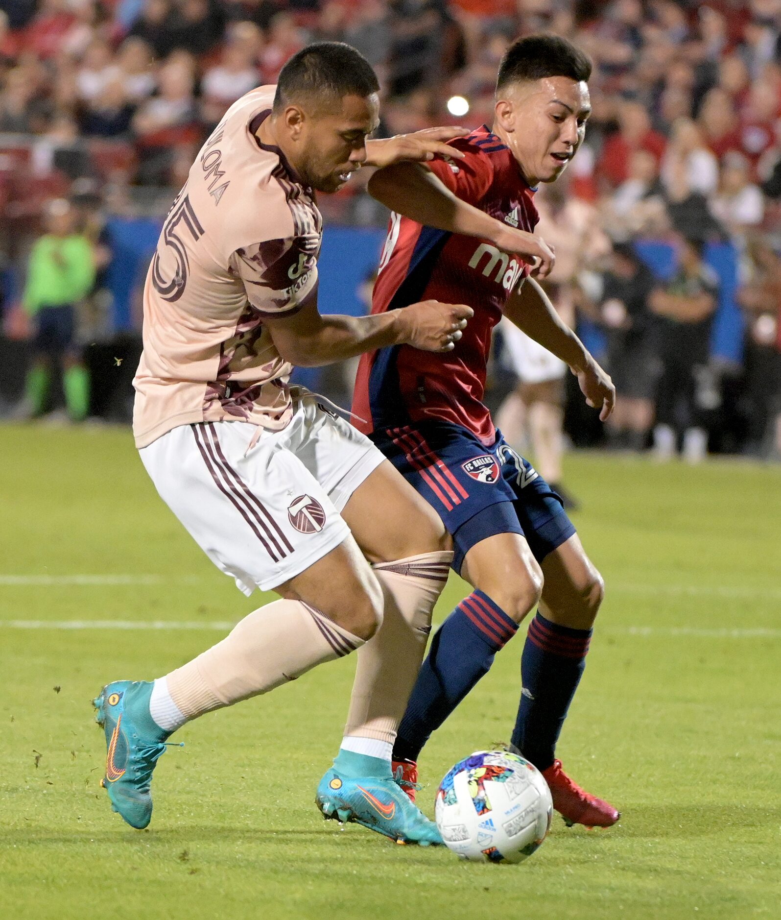 FC Dallas forward Alan Velasco (20) and Portland Timbers defender Bill Tuiloma (25) go after...