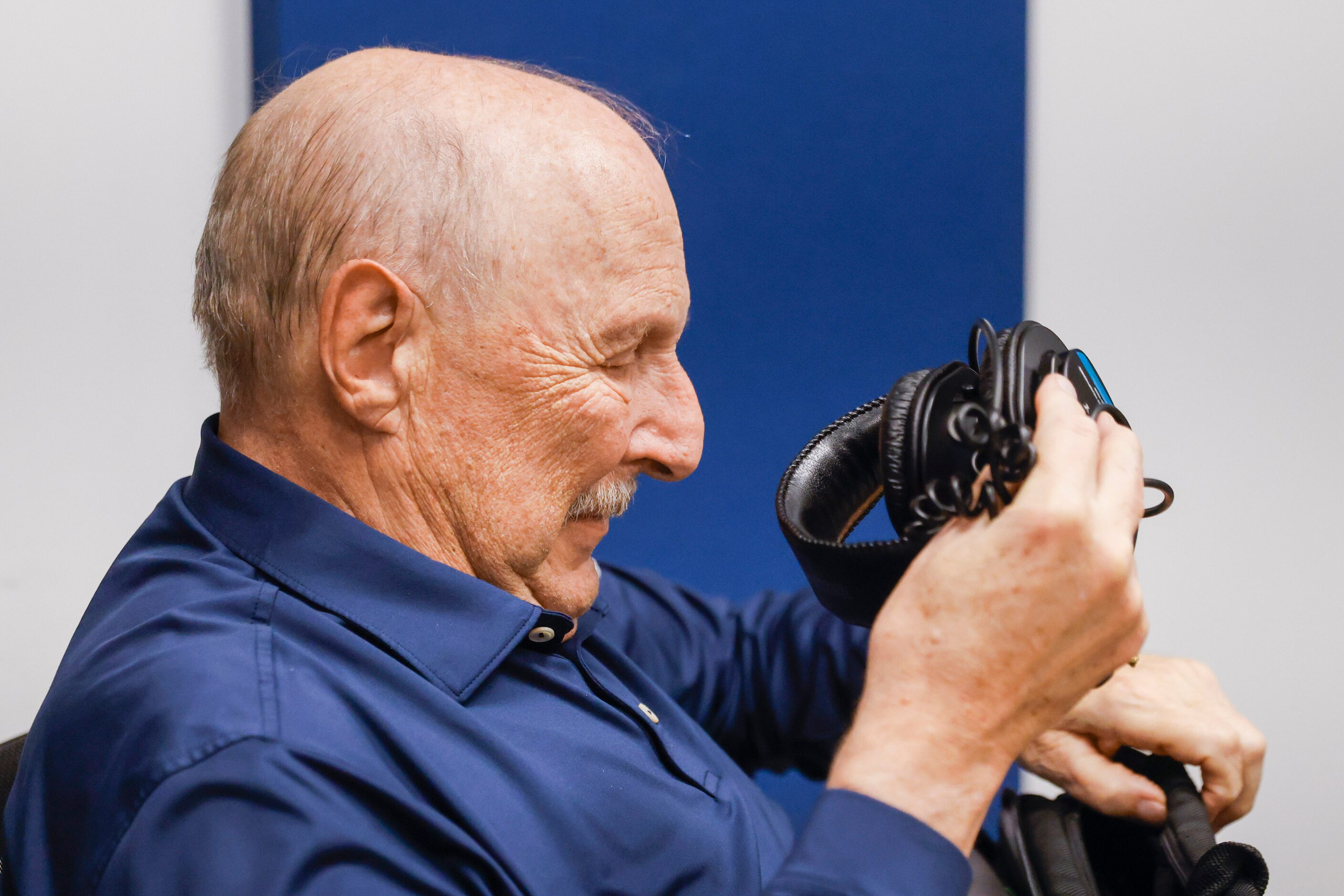 Local sports radio legend Norm Hitzges (left) packs his headphone as he signs off for the...