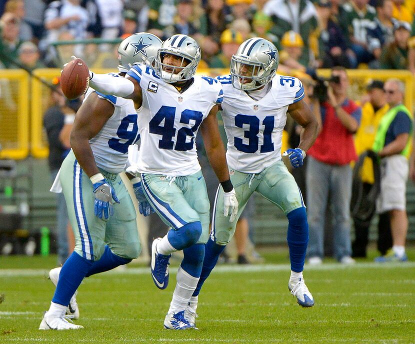 Dallas Cowboys strong safety Barry Church (42) celebrates after intercepting a pass by Green...