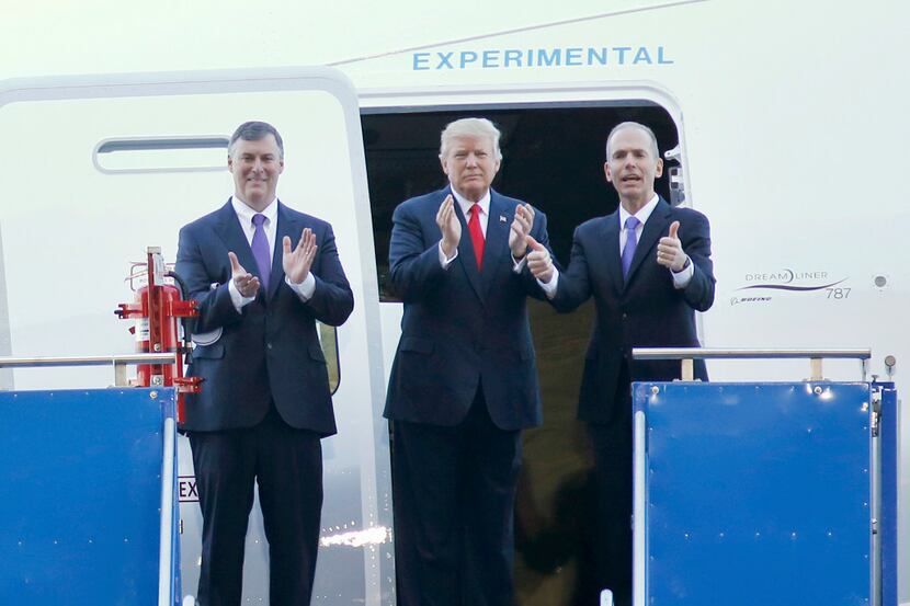 President Donald Trump stands by a Boeing 787-10 Dreamliner, with Boeing executive Kevin...