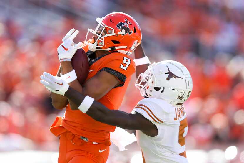 Oklahoma State wide receiver Bryson Green (9) catches a pass over Texas defensive back...