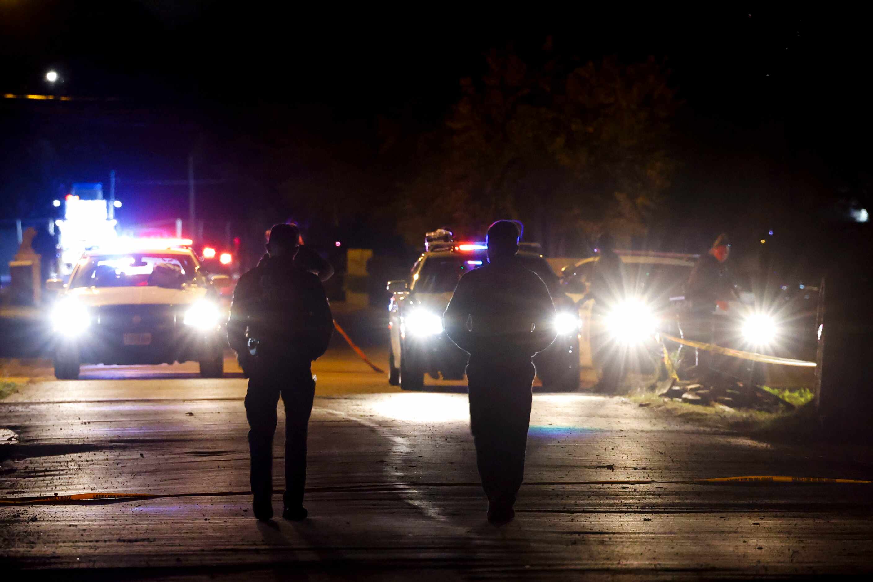 Dallas Police Department remain on a homicide scene leaving four people dead and a teenage...