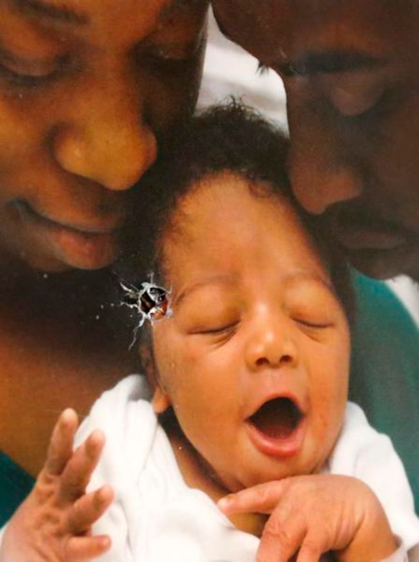 
A bullet pierced a photo of Quenetha Bell (left), Rubin Brown and their son, Lapoine, in...