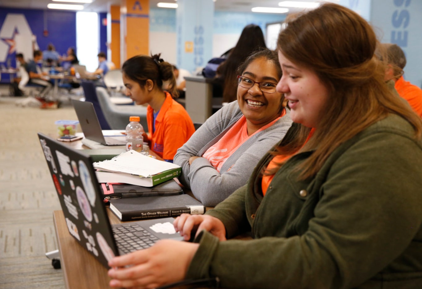 Crystal Ramirez (left), shares a laugh as she gets help from peer educator, Baleigh Zurn, at...