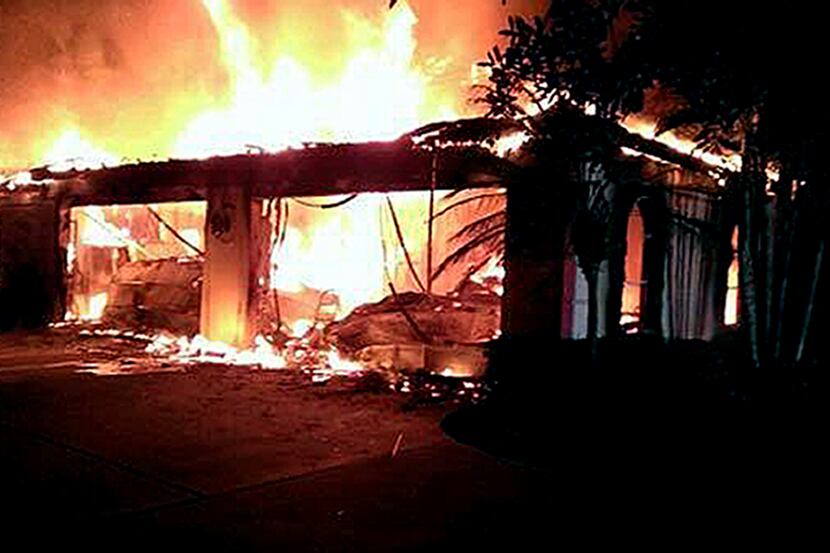 In this photo provided by the Hillsborough County Sheriff's Office, flames destroy a mansion...
