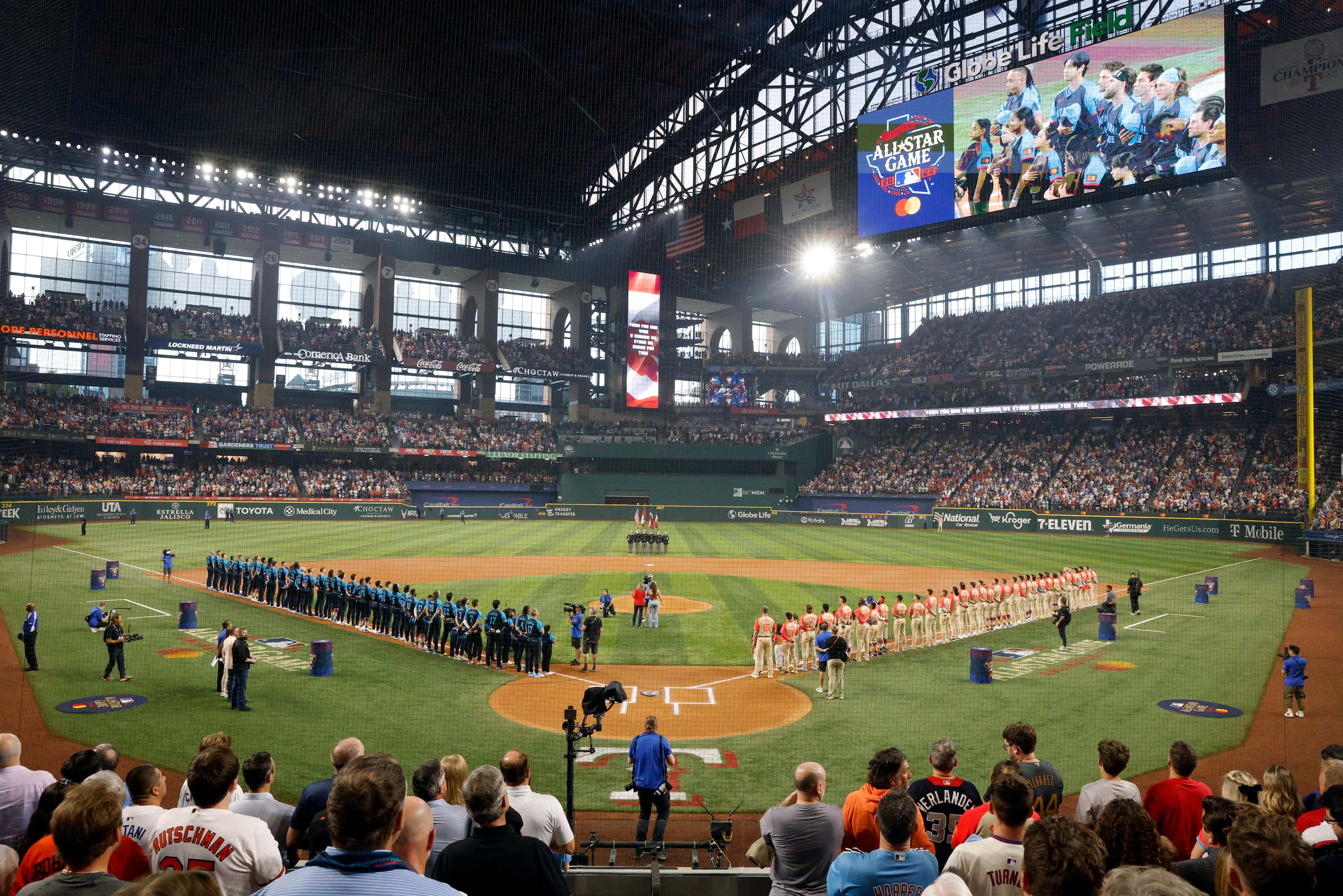 Members of the National League and American League All-Star teams stand for the national...