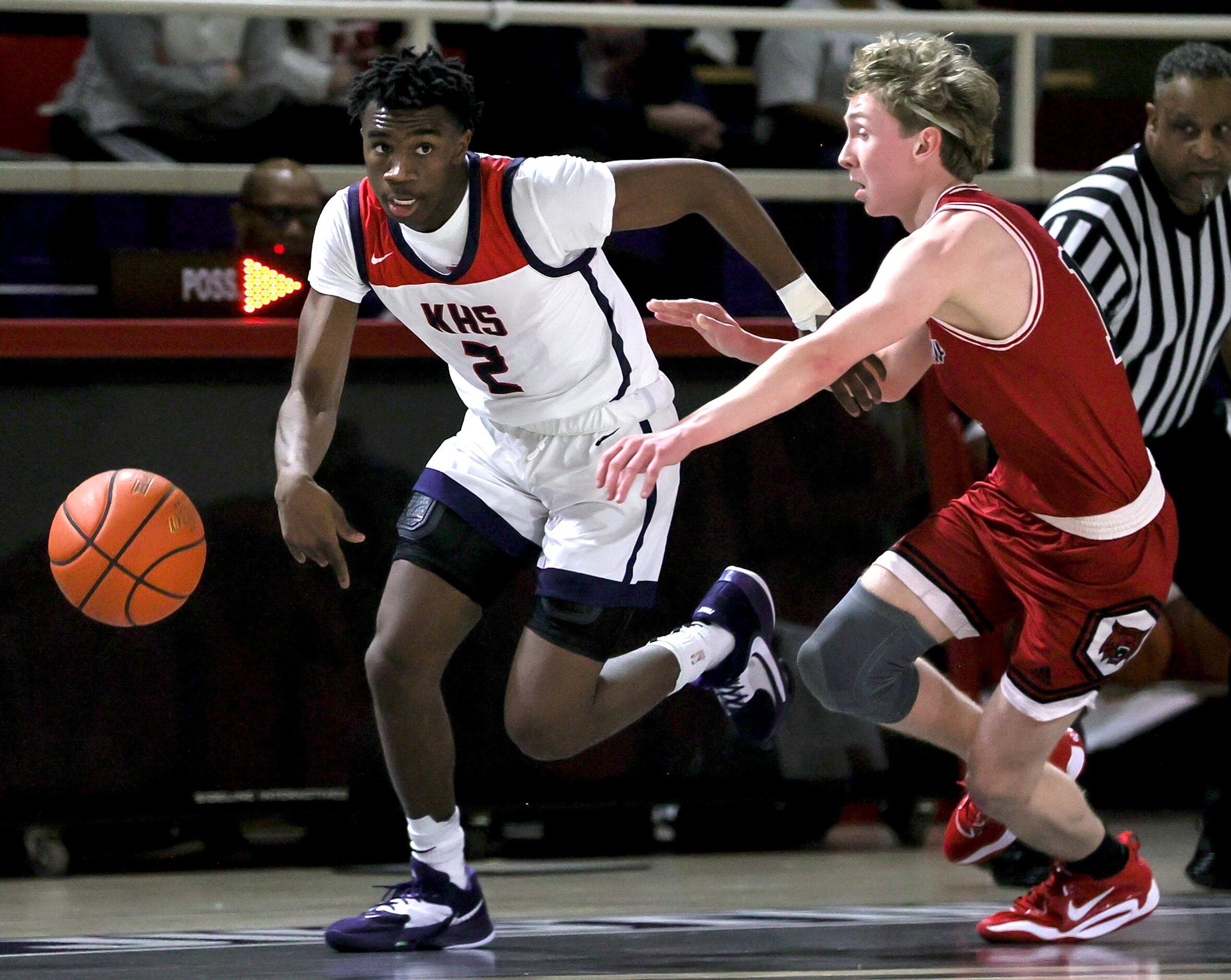 Kimball guard T'Johnn Brown (2) tries to get past Woodrow Wilson guard Brian Kirby, (right)...