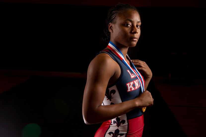 Wrestler Destiny Miles poses for a photograph at Kimball High School in Dallas on Thursday,...