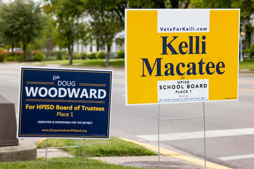 Kellie Macatee and Doug Woodward campaign signs photographed outside of the Highland Park...