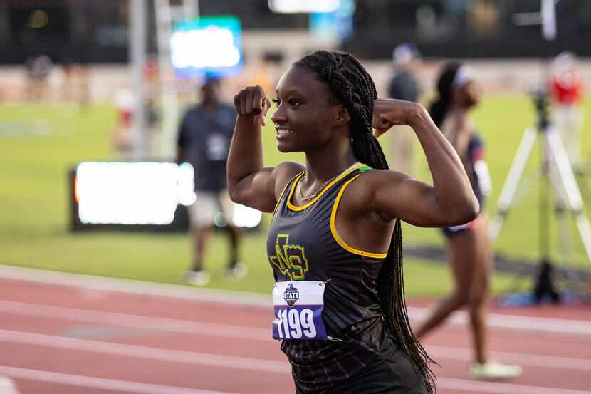 Aniyah Bigam of Carrollton Smith poses with arms flexed after the girls’ 200m dash at the...