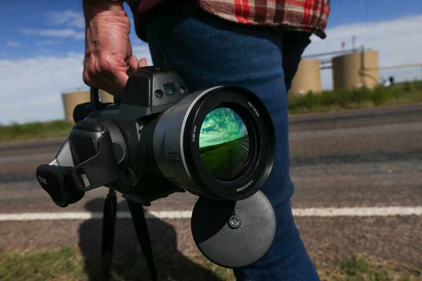 Sharon Wilson clasps a FLIR infrared camera as she prepares to record video of methane and...